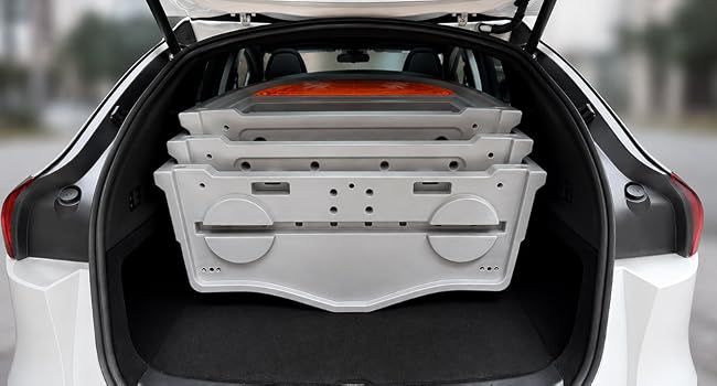 Disassembled KAYFISH boat sections loaded inside an SUV cargo area.