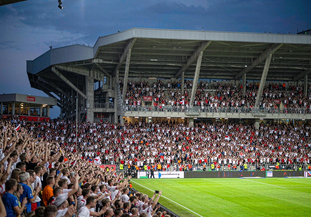 RB Leipzig fans at Red Bull Arena with red and white flags