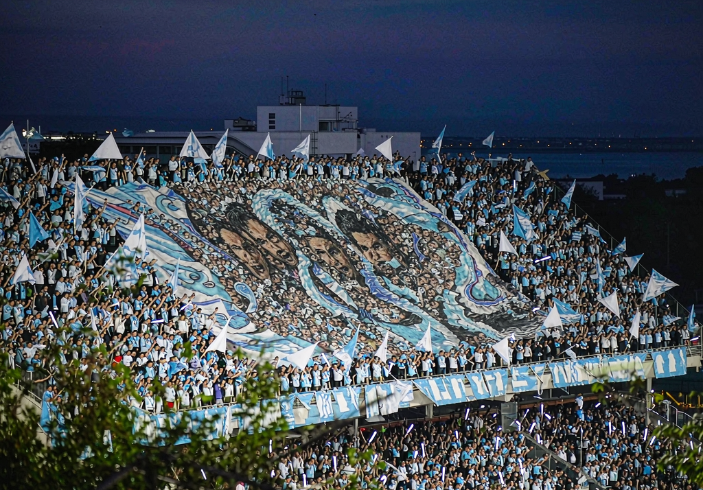 Marseille fans at Stade Velodrome with light blue and white flags