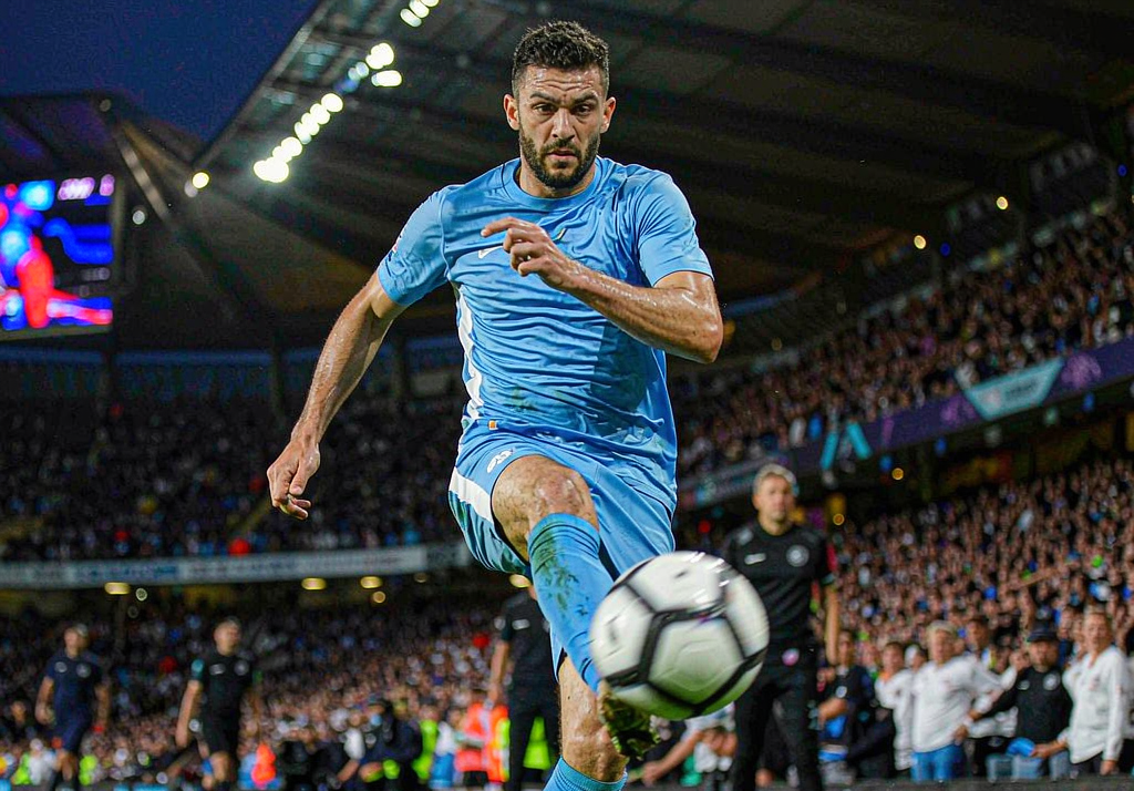 Manchester City player celebrating a goal at the Etihad