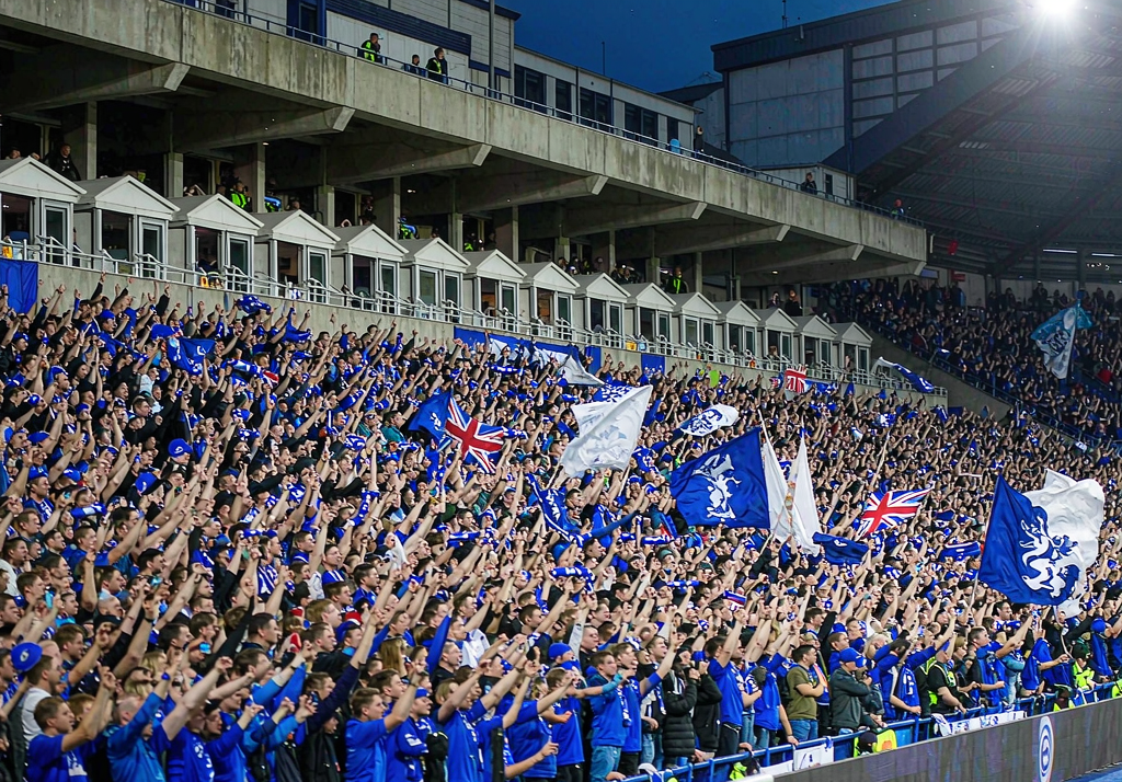 Chelsea fans at Stamford Bridge with blue flags and banners