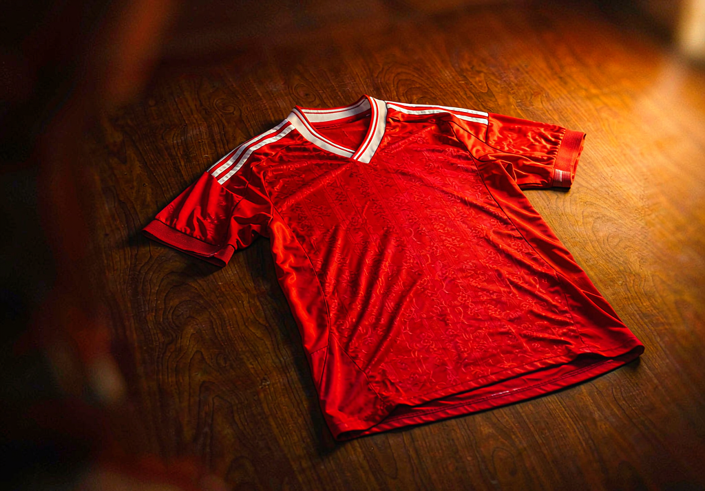 Liverpool 2026-27 home shirt on dark concrete with red and white details