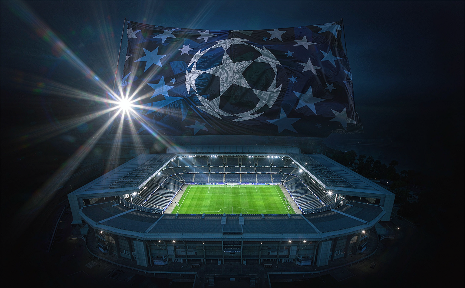 Champions League starball banner above a floodlit stadium