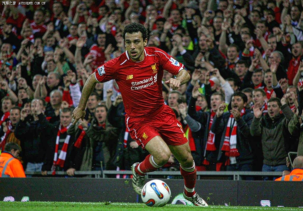 Liverpool player celebrating in front of the Kop at Anfield