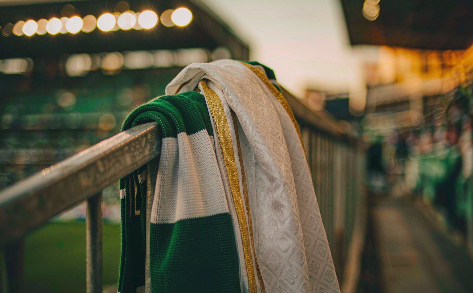 Green-and-white and white-and-gold scarves over the railings at the Estadio La Cartuja