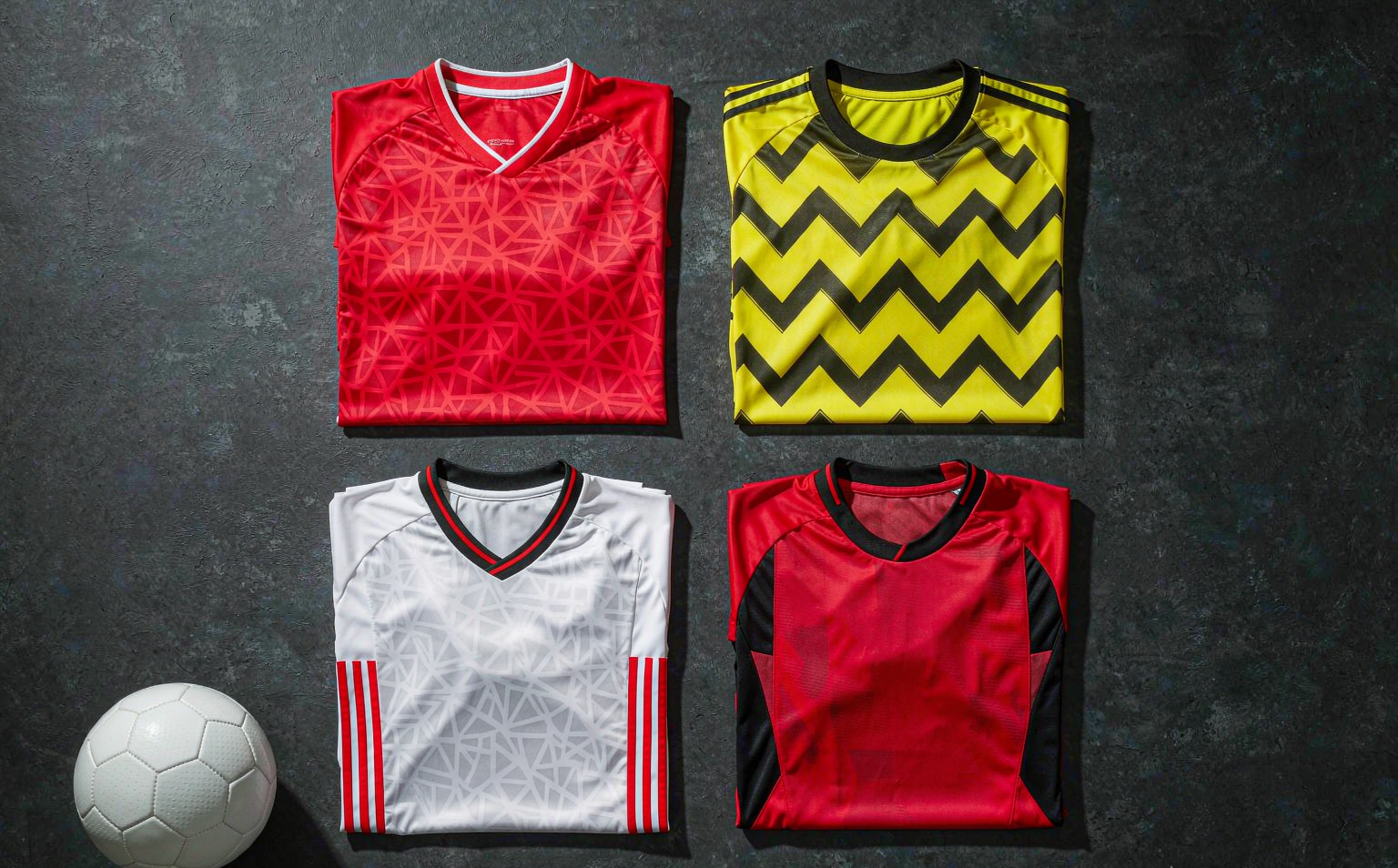 A selection of 2026-27 Bundesliga home shirts laid out on the pitch