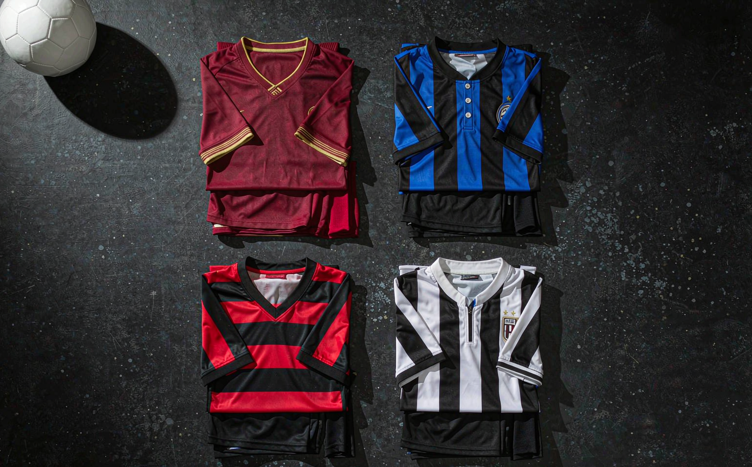 A selection of 2026-27 Serie A home shirts laid out on the pitch