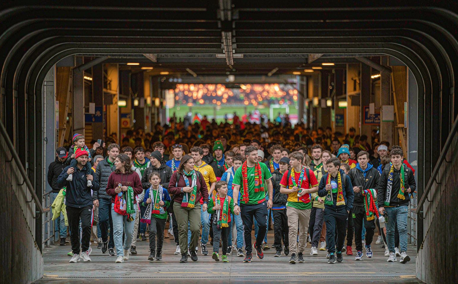 Fans walking through the stadium concourse before kick-off