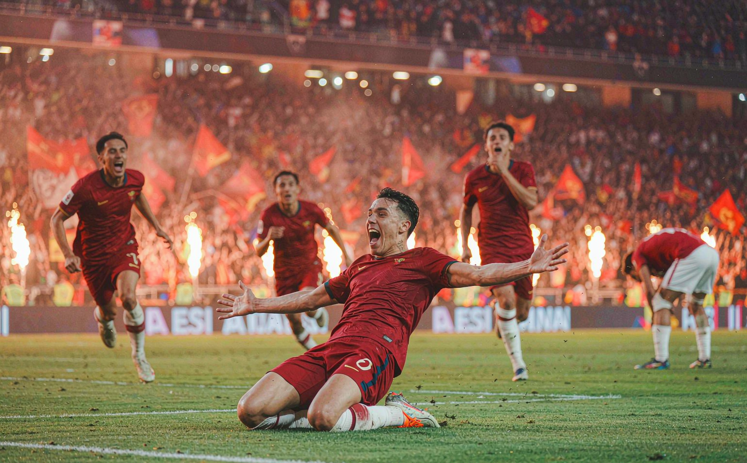 Roma player celebrating a goal in front of the Curva Sud