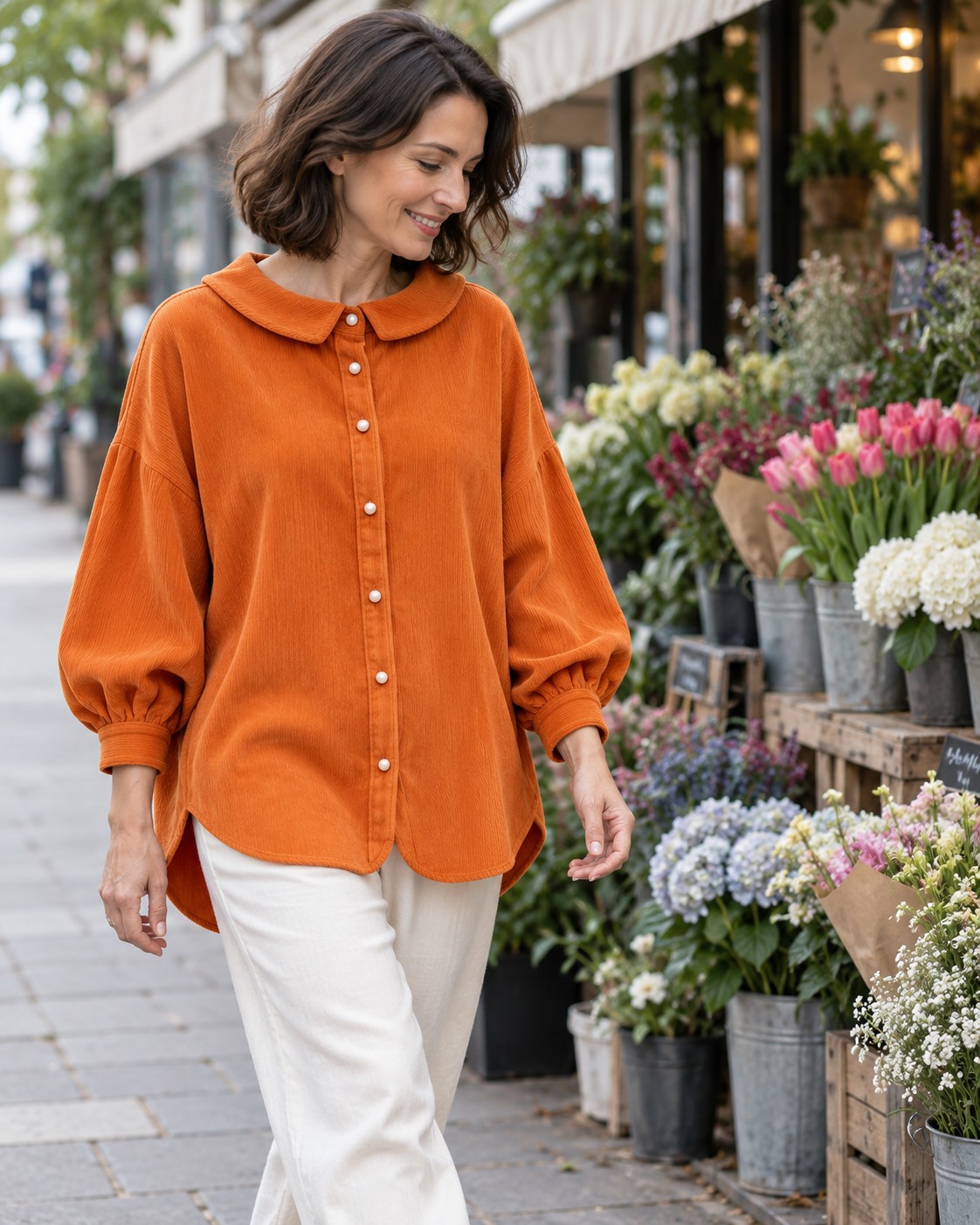 Orange rounded-collar shirt with ivory trousers on a walk past a flower market