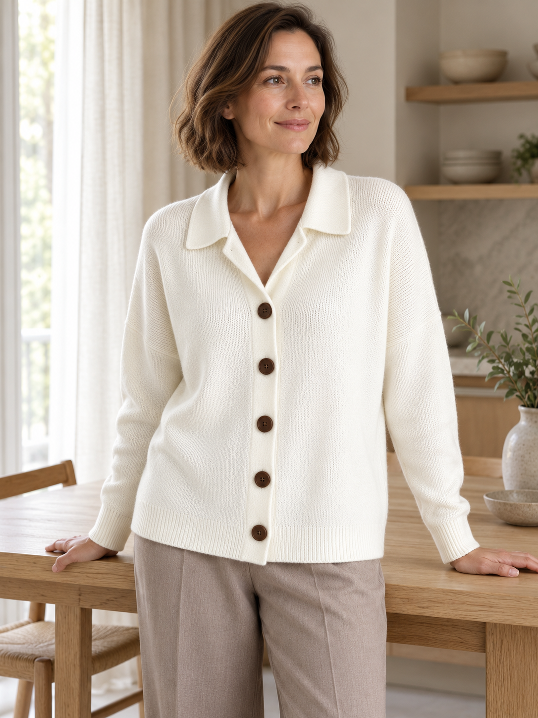Ivory five-button collared cardigan in soft window light
