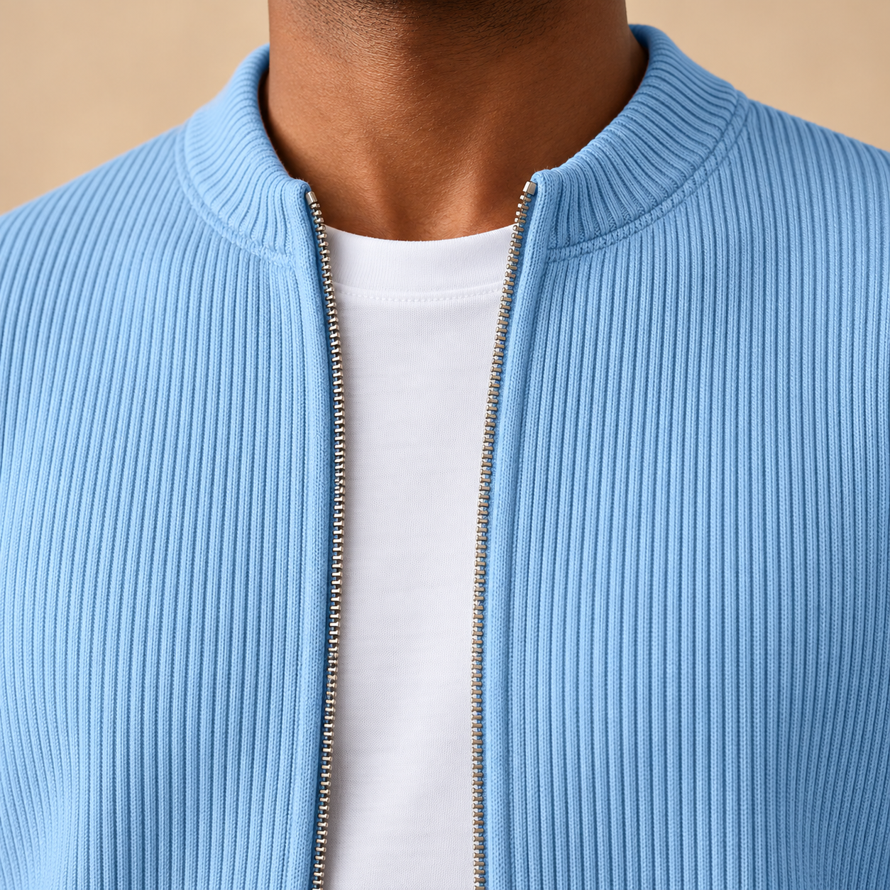 Close detail of the blue low stand collar and open full-zip front over a white T-shirt