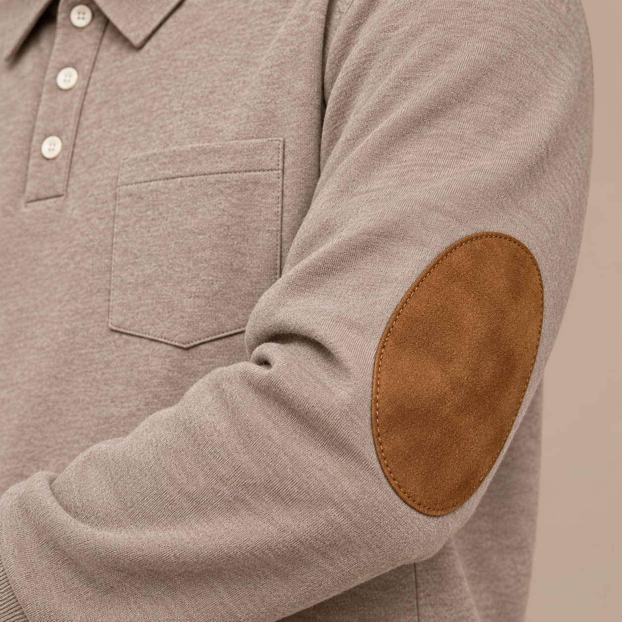 Close-up of brown oval stitched elbow patch on Heather Khaki fine-knit sleeve