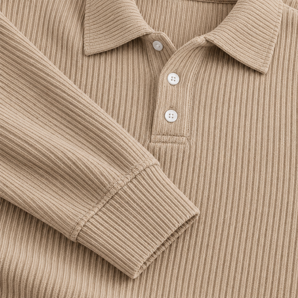Close-up of khaki vertical knit ribs and sleeve cuff