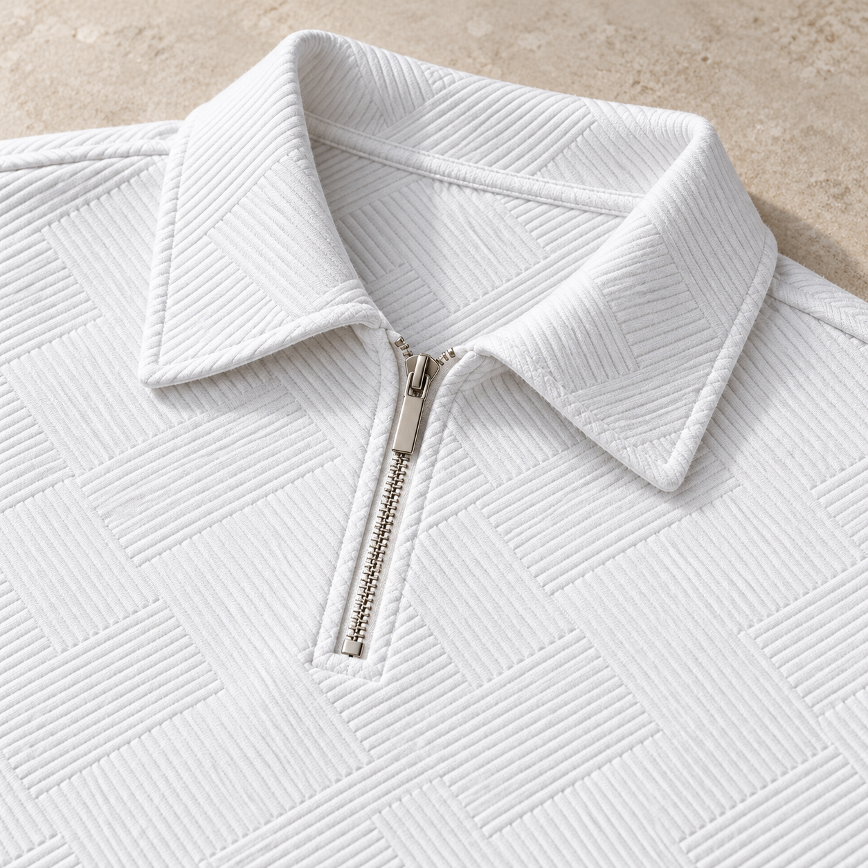 Close-up of the White folded pointed polo collar and short silver metal zipper