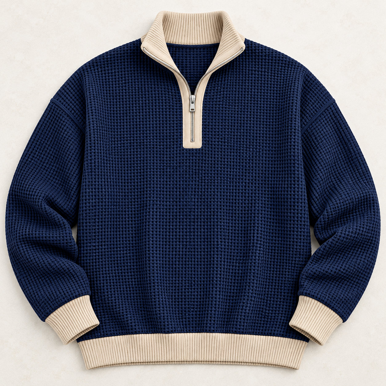 Complete navy quarter-zip laid flat with oatmeal collar, zipper placket, cuffs and hem
