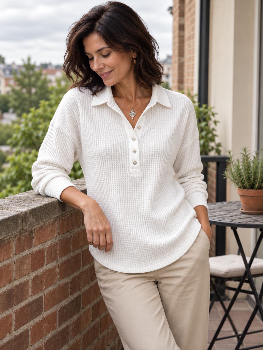 Pointed collar · short button placket · curved hem in a natural everyday setting