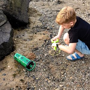 Boy on beach with tipped over Minecraft stainless steel water tumbler by zak! designs.