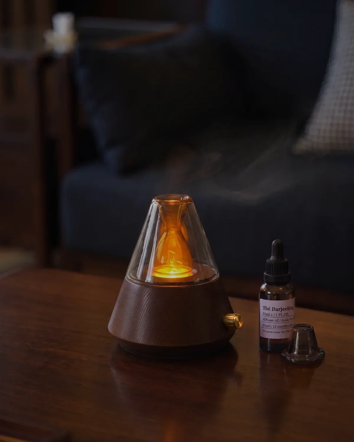 Chavanc waterless essential oil diffuser emitting subtle mist with warm amber ambient light and essential oil bottle