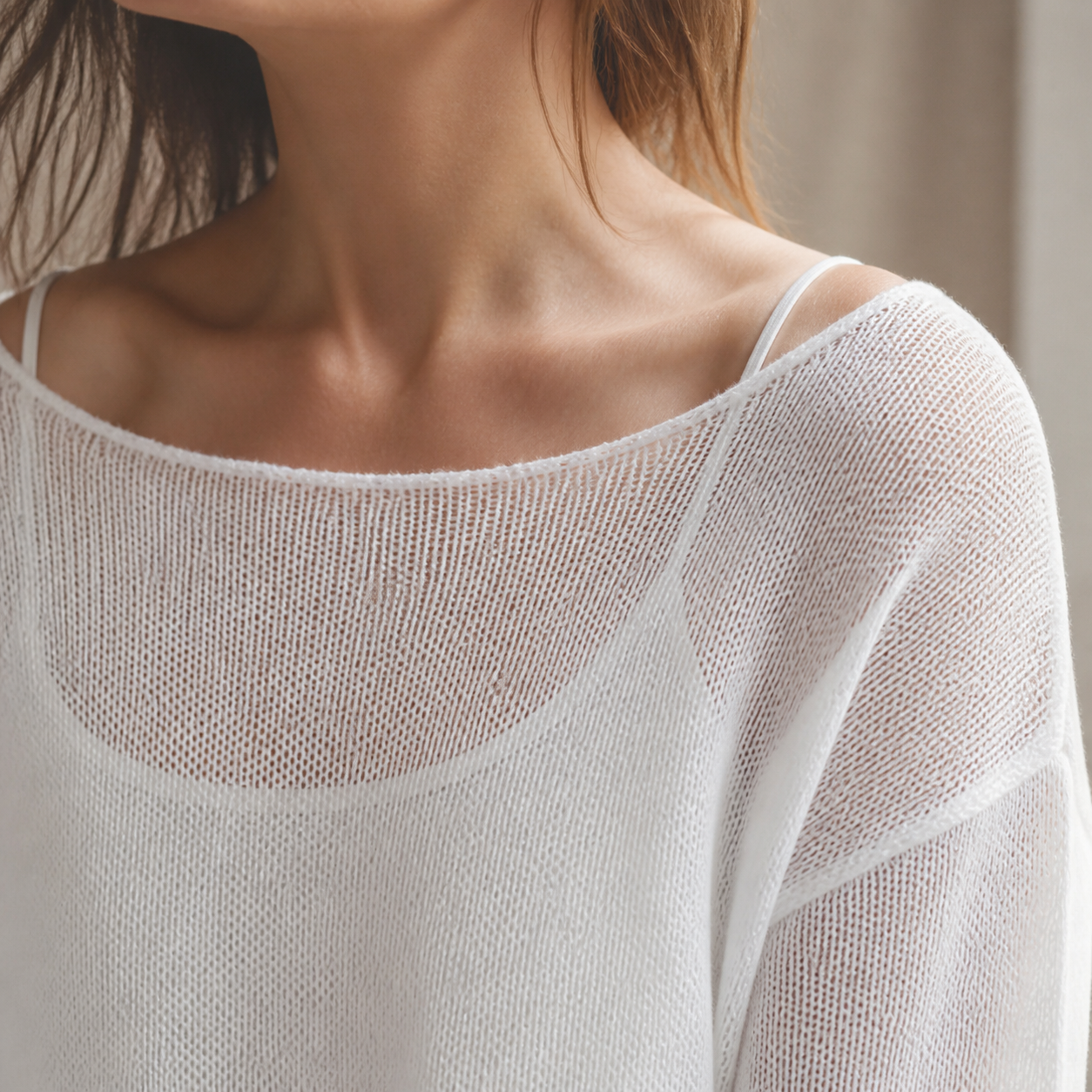 Close-up of airy open knit and boat neckline