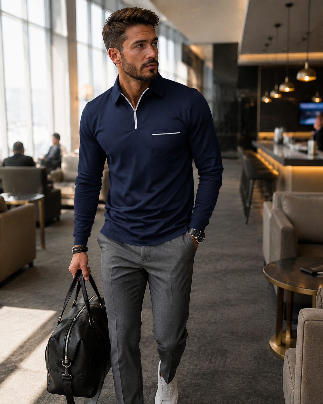 Navy Ronan polo in a modern travel lounge