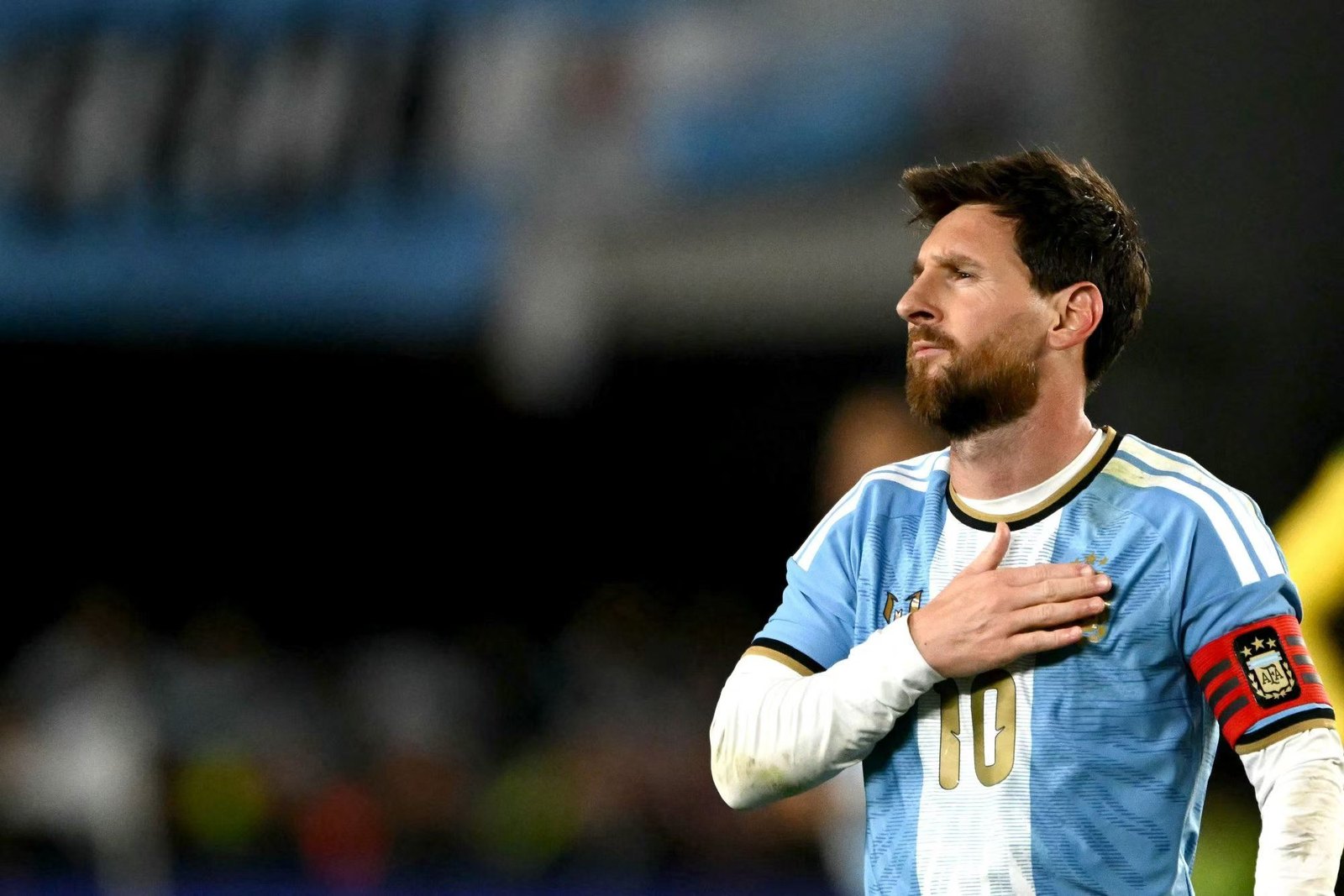Messi with his hand on the Argentina crest during the national anthem
