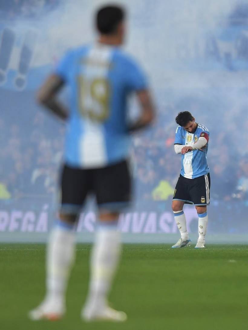 Messi looks down at his captain’s armband