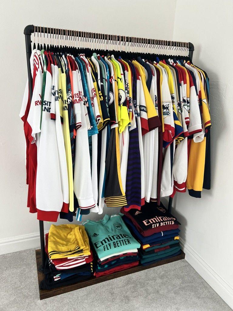 A collection of various 2026 jerseys neatly organized in a fan's closet