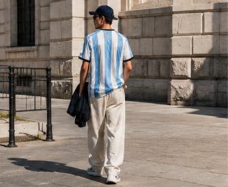 A cinematic editorial lookbook image capturing two modern fans styled in Argentina and Spain kits