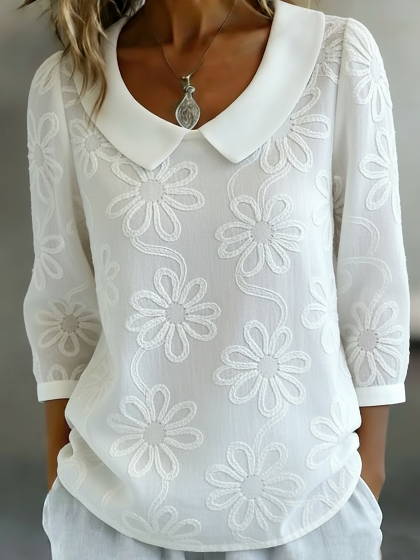 Elegant and comfortable long-sleeve shirt in solid color, decorated with embroidered floral patterns