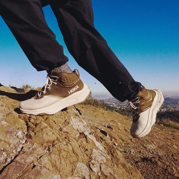 A person wearing trousers and the Transport Hike on a rocky hilly 