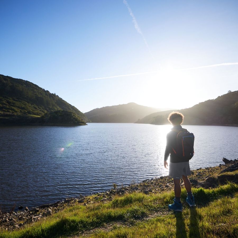 Person standing near a lake.