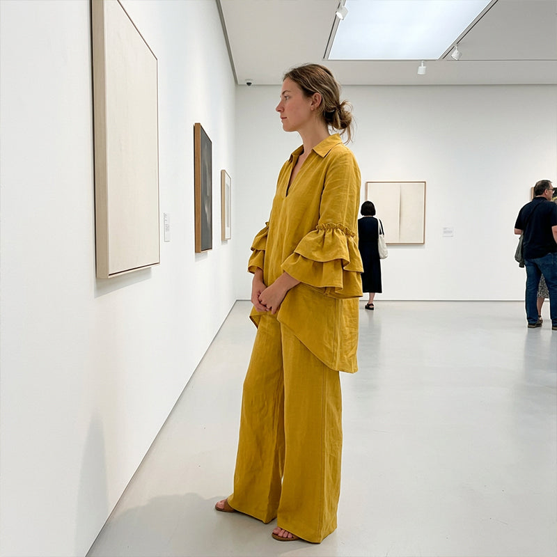 Woman styling the two-piece set for a gallery visit