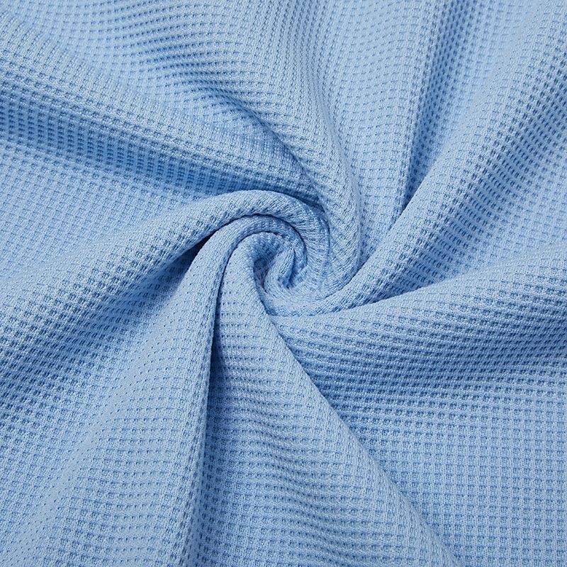 Soft stretchy waffle-knit fabric shown gathered by hand