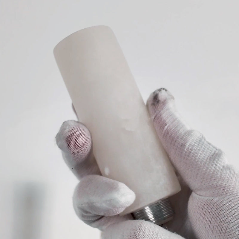 Hand holding the natural white alabaster stone cylinder shade