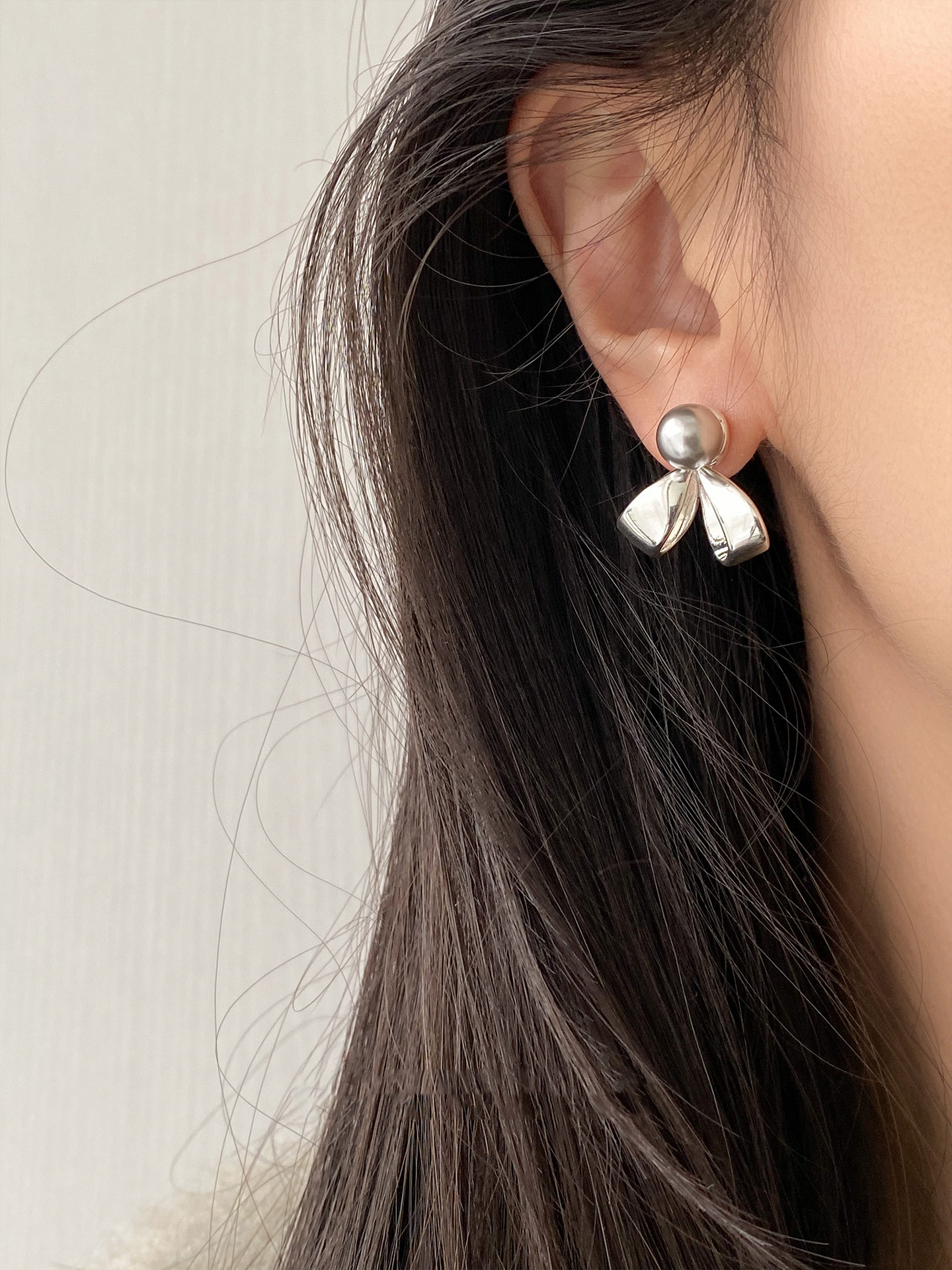 Cold Tone Grey Pearl Bow Earrings