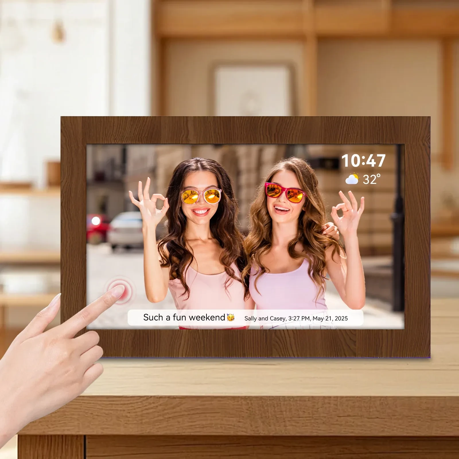 Digital photo frame with wood grain border displaying a photo of two women, touchscreen interface showing time, weather, and