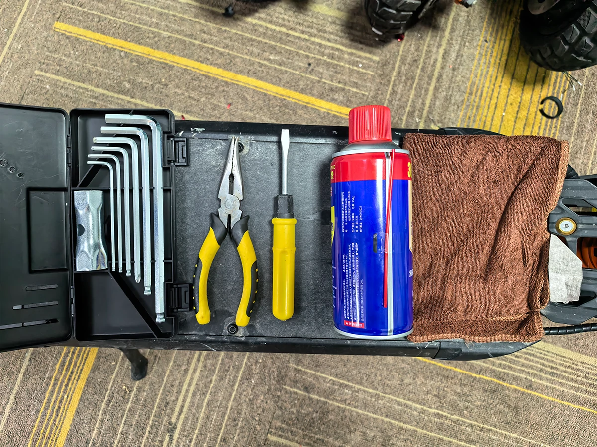 Tools needed to replace electric scooter brake pads, including Allen wrenches, pliers and a screwdriver