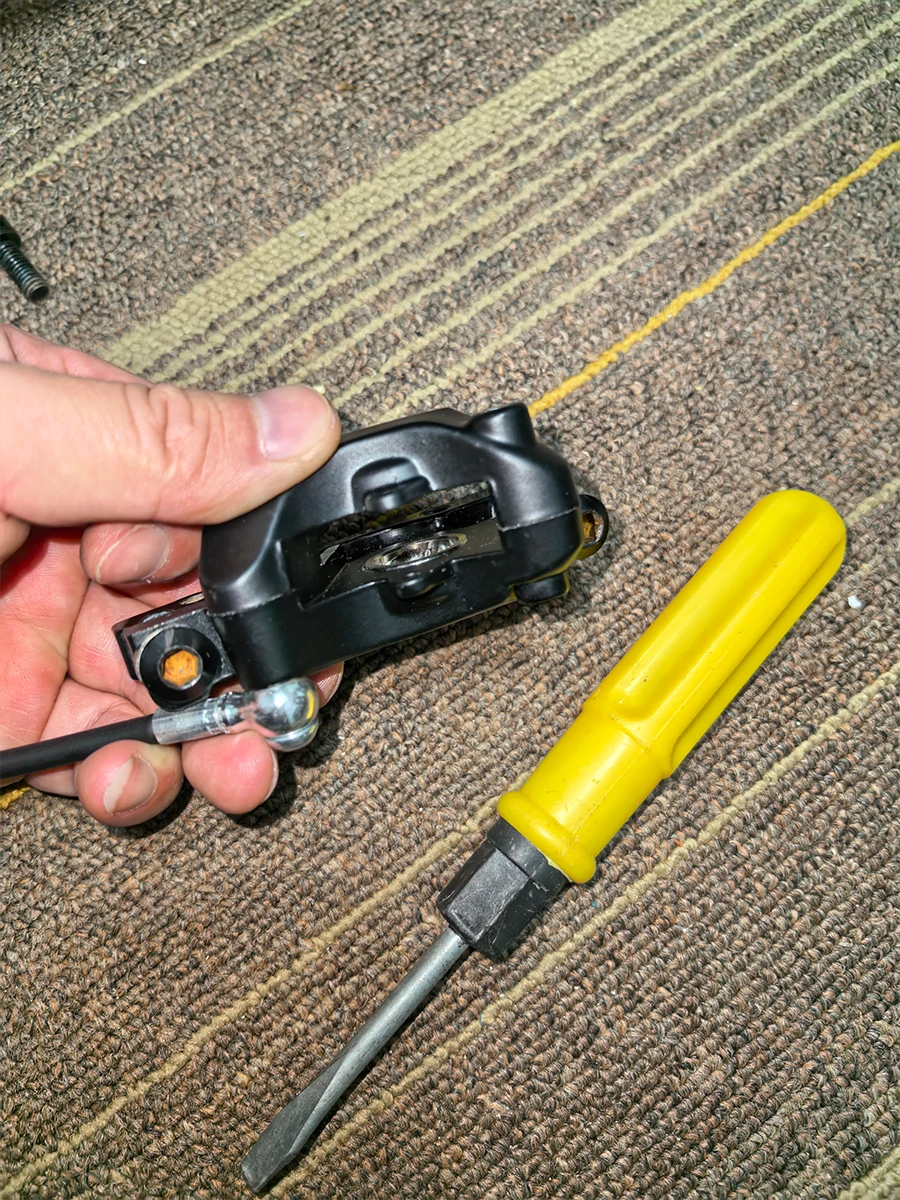 Retracting an electric scooter hydraulic brake caliper piston before installing new brake pads