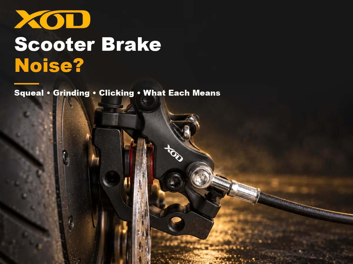 A wet rotor passes between caliper pads beside a solid scooter hub and a small road tire.