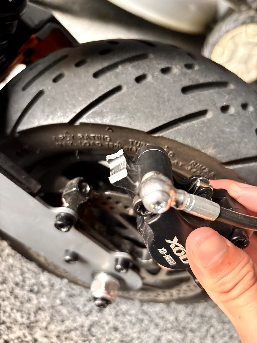 XOD hydraulic brake caliper damage caused by missing mounting bolt metal washer