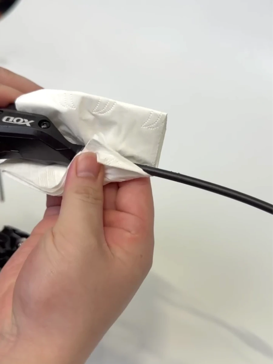 Wiping the XOD hydraulic brake hose connection clean after installation