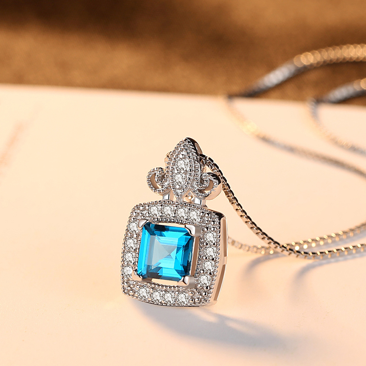 Sterling Silver Princess Cut Blue Topaz Pendant Necklace with Crown Design