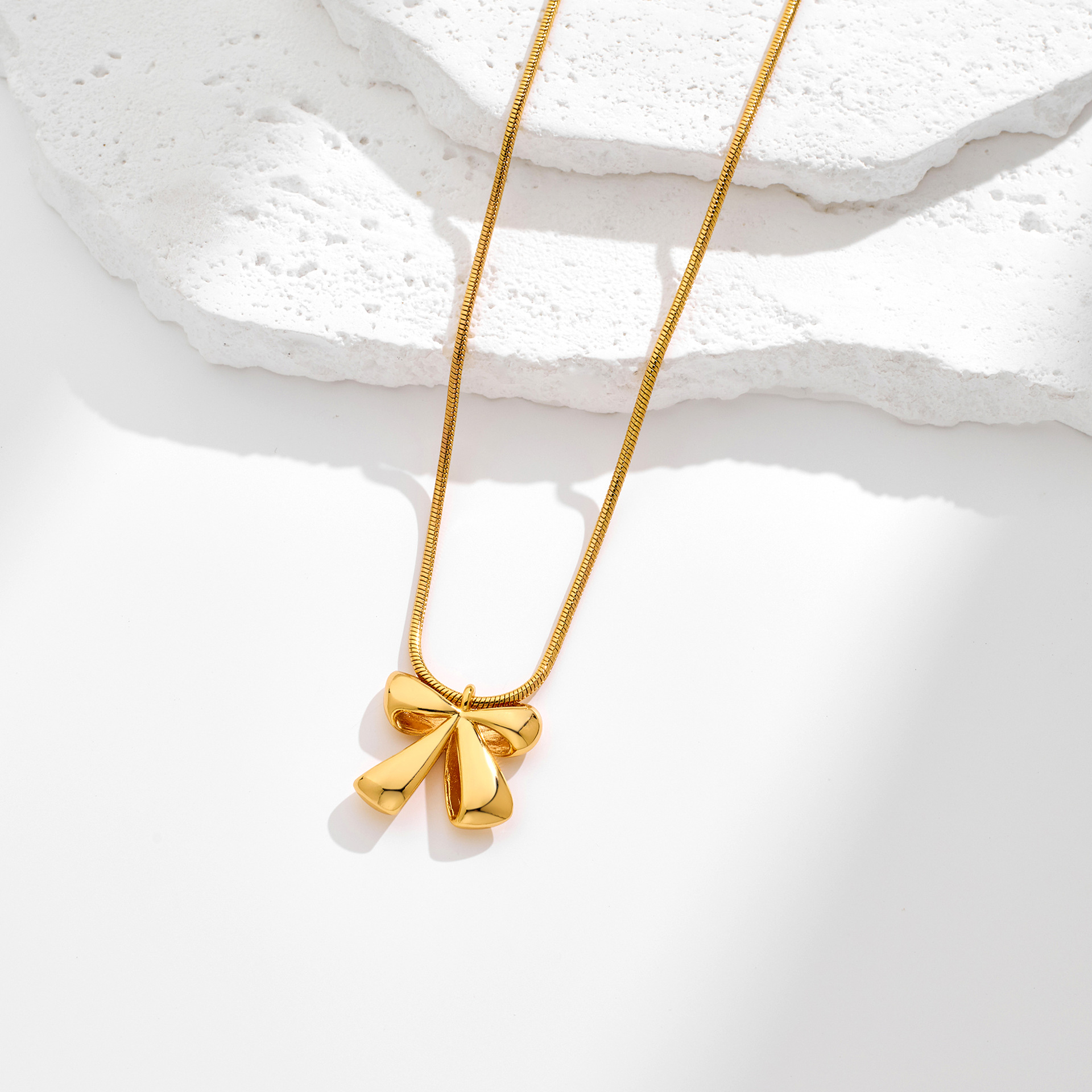 Elegant Gold-Plated Brass Bow Pendant Necklace with Snake Chain