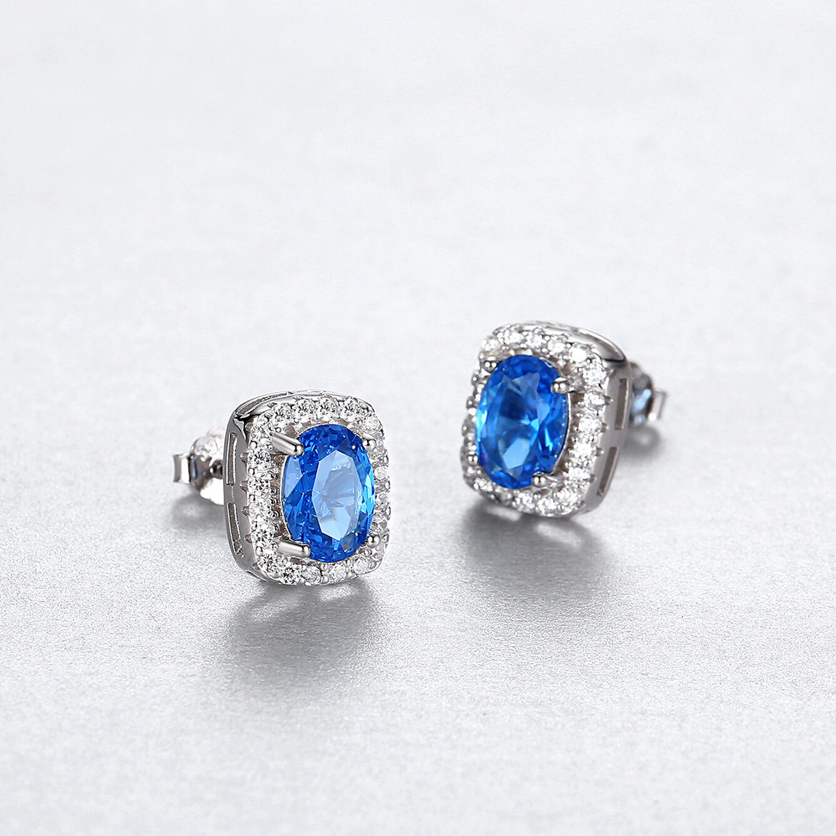 Regal Blue Sapphire Halo Stud Earrings with Double Row Pave Set in Silver Tone