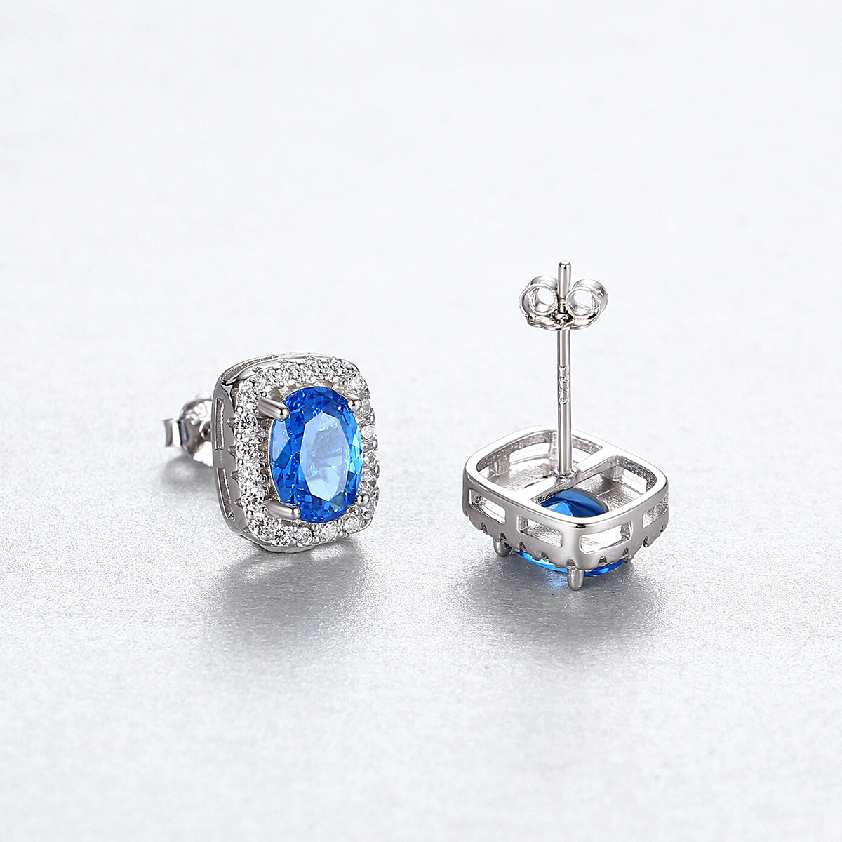 Regal Blue Sapphire Halo Stud Earrings with Double Row Pave Set in Silver Tone