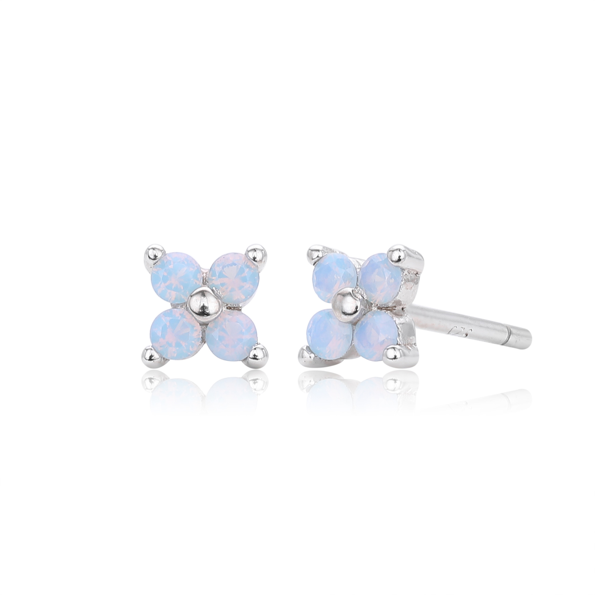 ese delicate stud earrings feature a charming four-petal flower design with faceted light blue