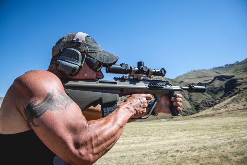 Shooter holding a rifle with mounted Night Stalker Mini Weapon Mounted Scope.