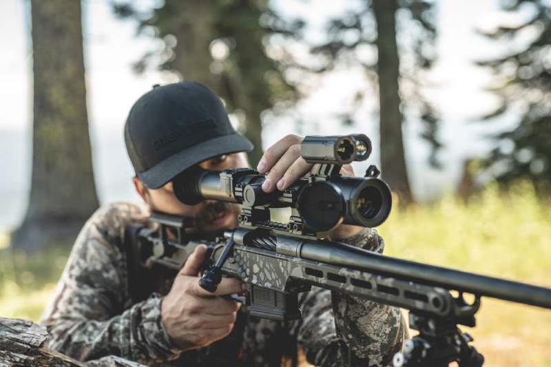 Hunter using DS35 LRF night vision scope on a rifle in the field.