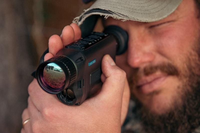 Male hunter using a  NV009 Night Vision Monocular.